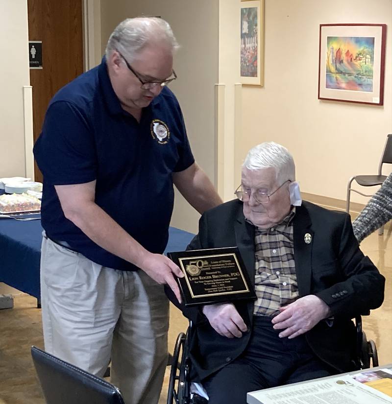 Lions of Illinois Foundation Member Ron Fruit presents an award to Roger Brunner for his service to the Oregon Lions Club.