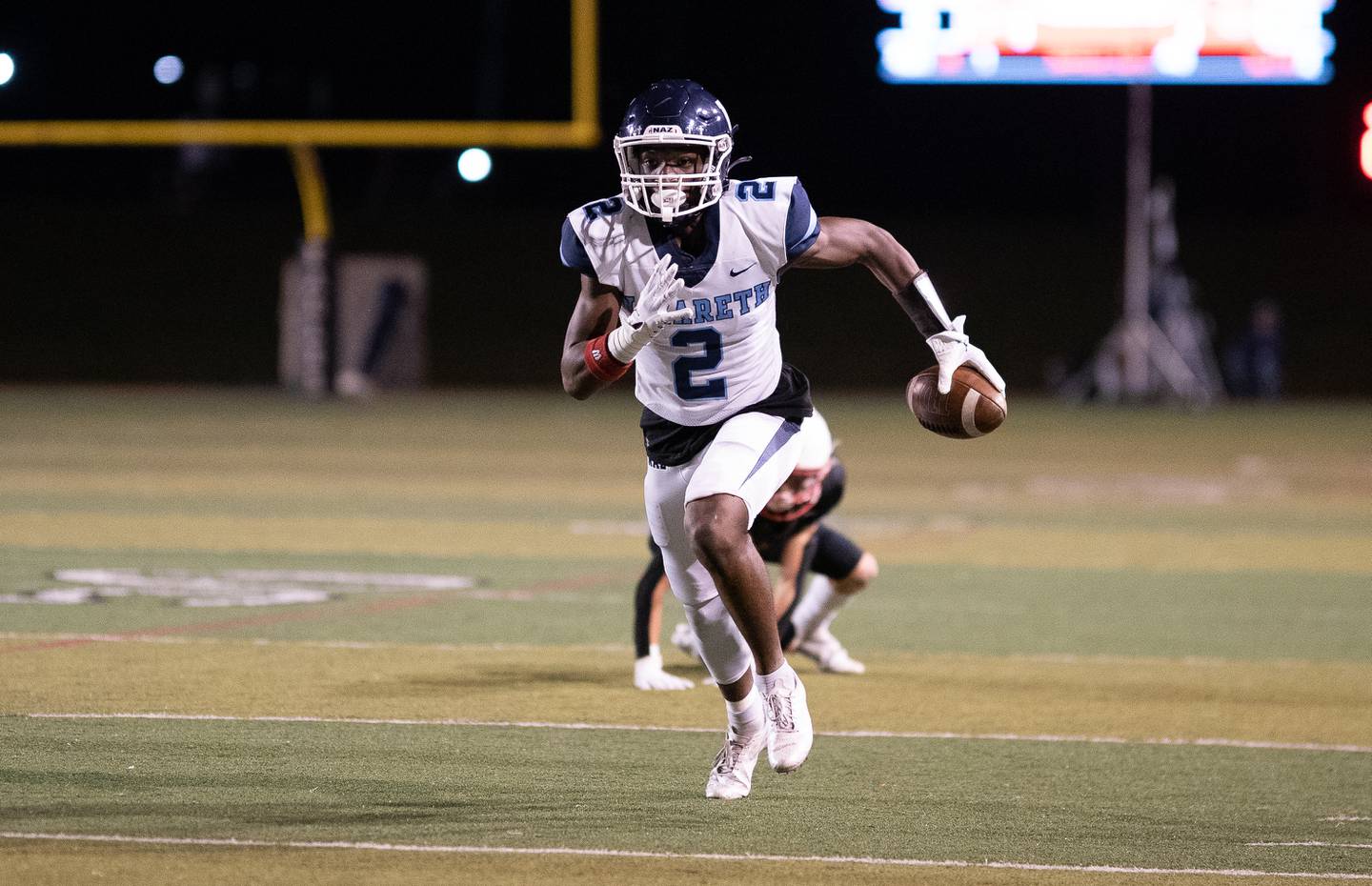 Nazareth Academy's Justin Taylor (2) runs after the catch against Benet Academy during a football game at Benedictine University in Lisle on Friday, Oct 21, 2022.