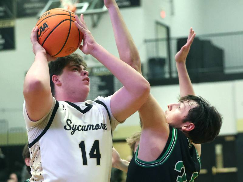 Sycamore's Michael Chami goes up for a shot against North Boone's Ronnie Ragland during their game Tuesday, Dec. 3, 2024, at Sycamore High School.