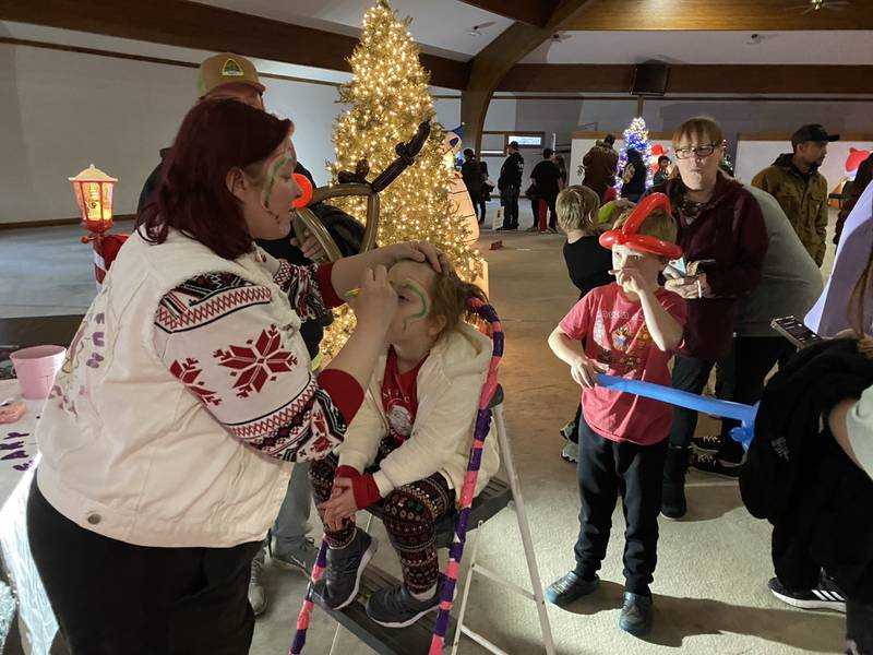 Adalynn gets her face painted during An Evening with Santa.