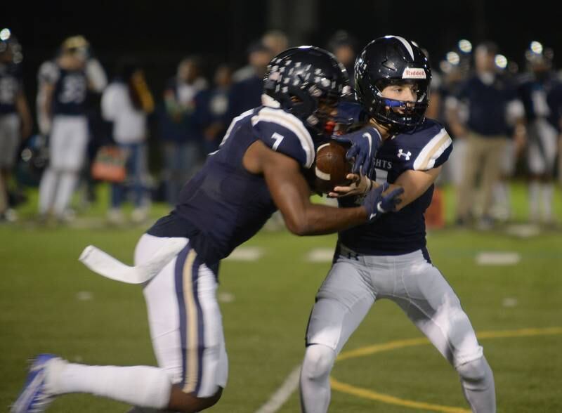 Immaculate Conception's Dennis Mandala hands the ball off to Denzell Gibson during their home game against Wheaton Academy Friday Sept 30, 2022.