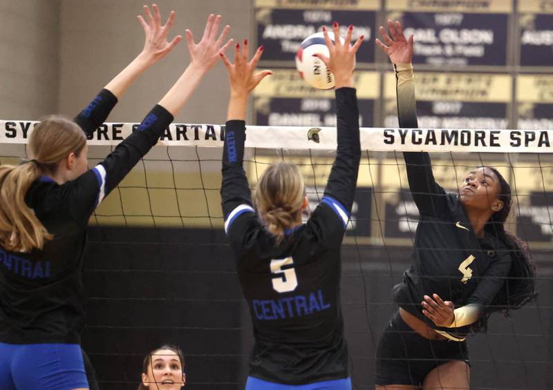 Sycamore's Khiara Thomas tries to spike the ball by a pair of Burlington Central blockers Tuesday, Oct. 29, 2024, during their Class 3A regional match at Sycamore High School.