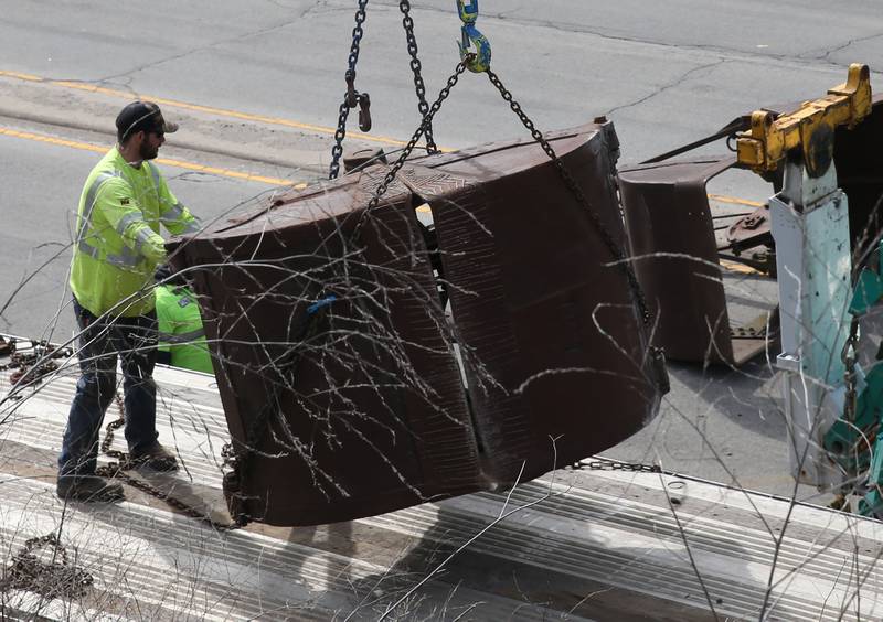 Crews with Senica Towing work the scene of a semi that struck the 7th Street bridge over Illinois Route 251 on Monday, March 10, 2025 in Peru. The semi was hauling two clamshell buckets for excavating equipment.