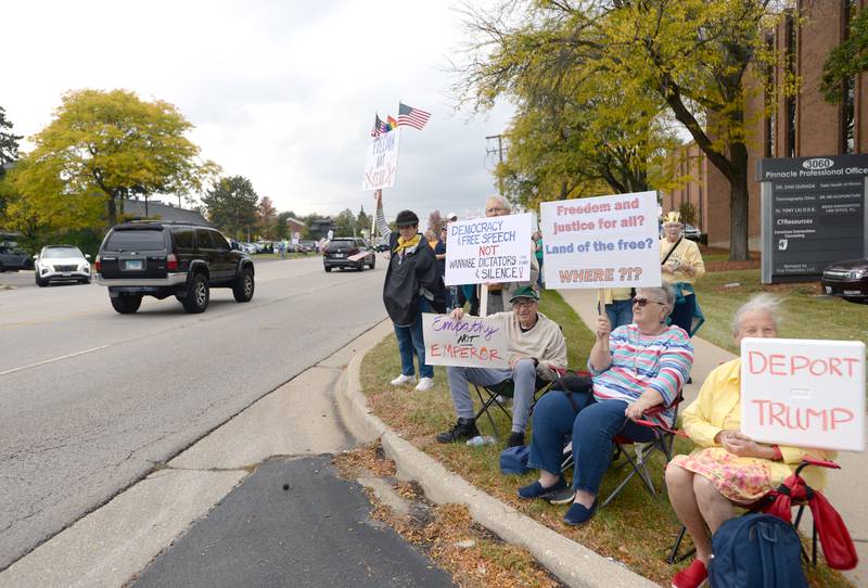 Residents of Oak Trace Senior Living in Downers Grove (left-right) Marty Kraus, Beverly Roselieb, and Sibylle Sonnenberg participate in the No Kings Day Rally in Lisle Saturday Oct 18, 2025. This rally in Lisle takes place every Saturday.