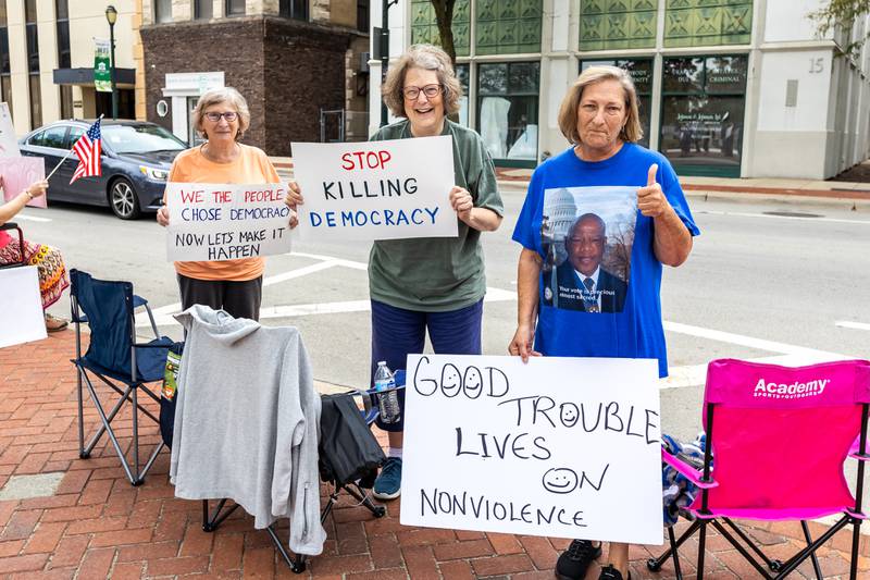 Cathy Duncan, Sarah Ahlgren, and Patricia Carlin participate in the Good Trouble Lives On event in Downtown Joliet on July 17, 2025.