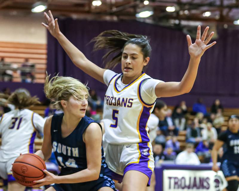 Downers Grove North's Campbell Thulin (5) defends Downers Grove South's Allison Jarvis (14) during girls basketball game between Downers Grove South at Downers Grove North. Dec 16, 2023.