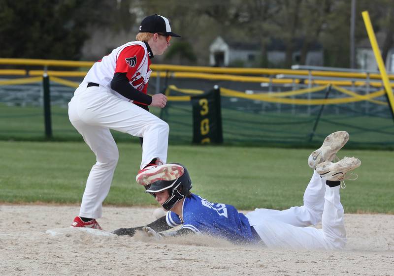 Hinckley-Big Rock's Skyler Janeski slides under Indian Creek's Tyler Bogle for a stolen base during their game Monday, May 1, 2023, at Indian Creek High School in Shabbona.