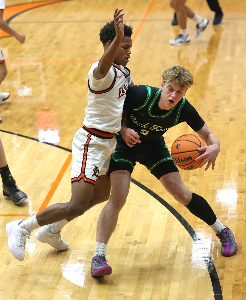 DeKalb's Bryan Miller plays tight defense against Rock Falls' Cole Heald during their game Tuesday, Dec. 2, 2025, at DeKalb High School.