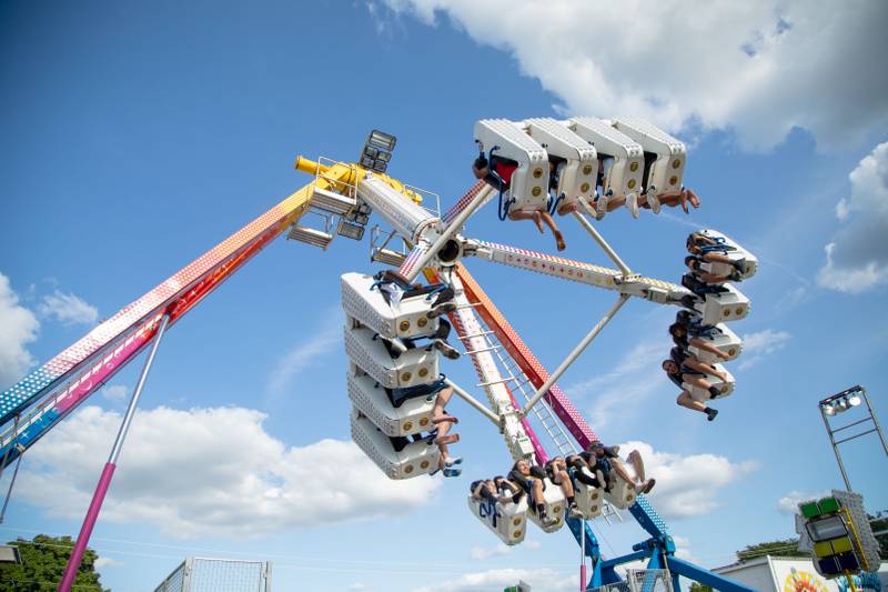 Patrons enjoy a carnival ride during the DuPage County Fair at the DuPage Event Center & Fairgrounds on Saturday, July 30, 2022.