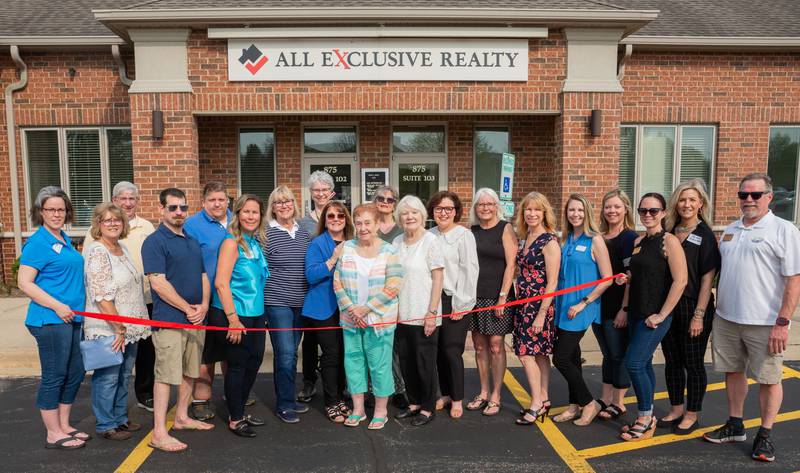 Shirley Rochford celebrates joining the All Exclusive Realty team with a ribbon cutting ceremony on May 11, 2022.  She is join by the staff and board members of the Cary-Grove Area Chamber of Commerce.