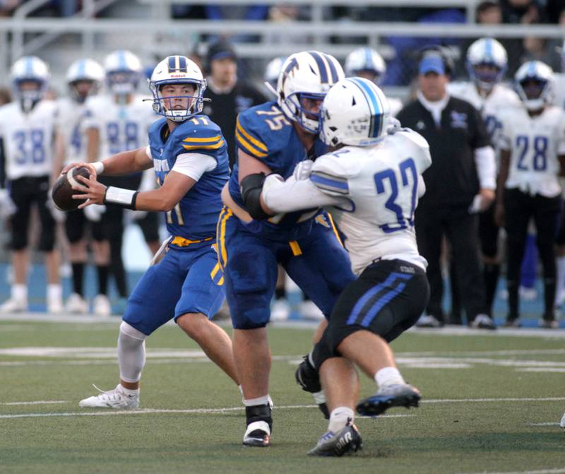 Wheaton North quarterback Max Howser looks to pass the ball during a game against St. Charles North in Wheaton on Friday, Sept. 8, 2023.