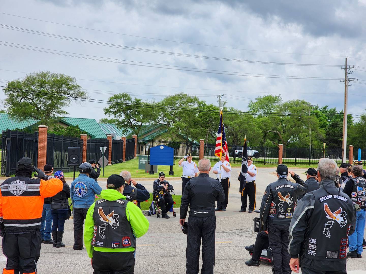 Participants gather in a parking lot at the Lovell Federal Health Care Center for a pre-ride ceremony before the 2024 Rolling Thunder MId-America Demonstration Parade.
