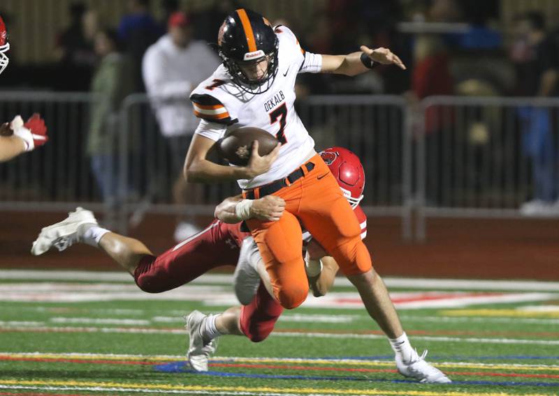 DeKalb quarterback Adrien McVicar is sacked by Naperville Central inside linebacker Ethan Pytlak during their game Friday, Oct. 8, 2021, at Naperville Central High School.
