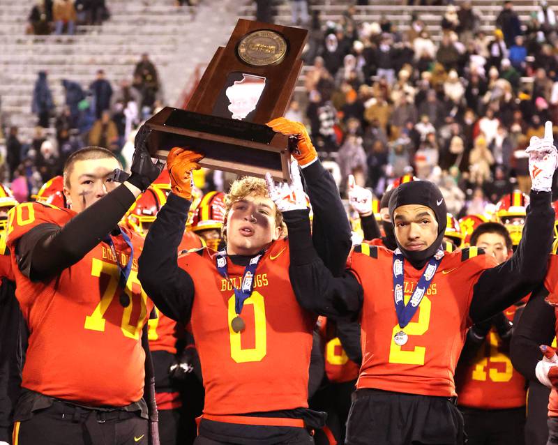 Batavia players hoist the second place trophy after their Class 8A state championship game loss to Mt. Carmel Saturday, Nov. 30, 2024, in Hancock Stadium at Illinois State University in Normal.