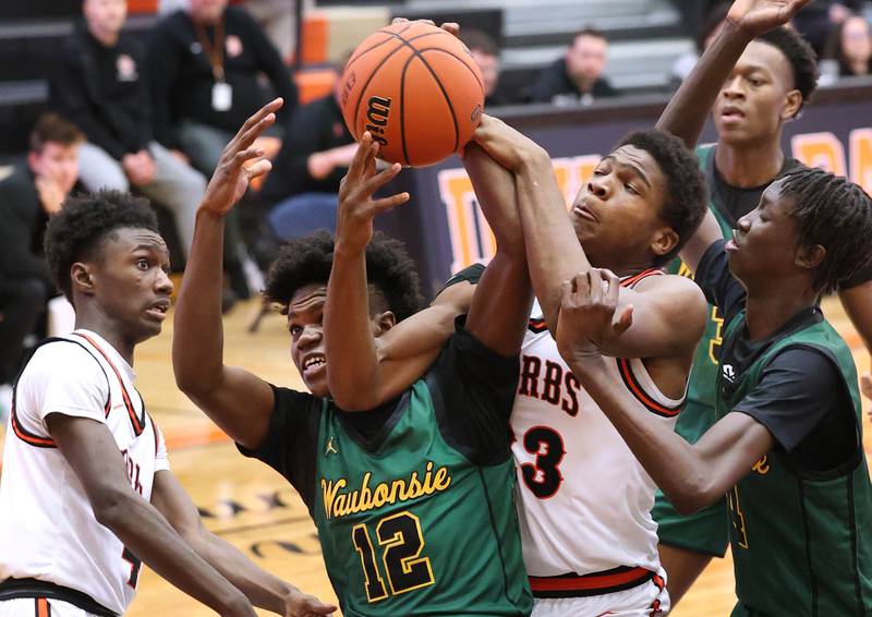DeKalb’s Davon Grant and Waubonsie Valley's Tyreek Coleman fight for a rebound during their game Friday, Dec. 15, 2023, at DeKalb High School.