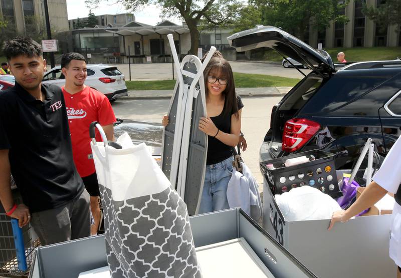 Kenadi Johnson, (middle) a sophomore at Northern Illinois University from Chicago, gets some help from other NIU students Wednesday, Aug. 21, 2024, as she moves into Patterson Hall during the first of two move-in days for new students at NIU in Dekalb.