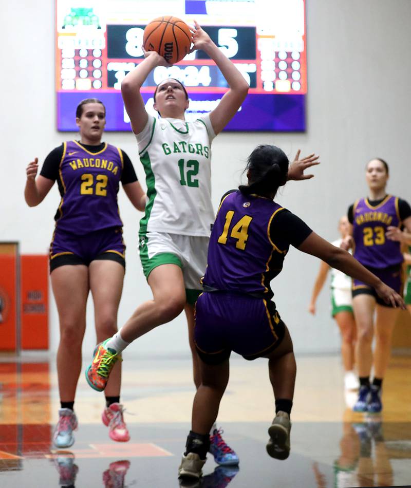 Crystal Lake South's Gaby Dzik (center) shoots the ball between Wauconda's Kelsey Piehl (left) and Alexia Manalo (right) during the Northern Illinois Holiday Classic Championship girl basketball game on Thursday, Dec. 18, 2025, at McHenry High School.