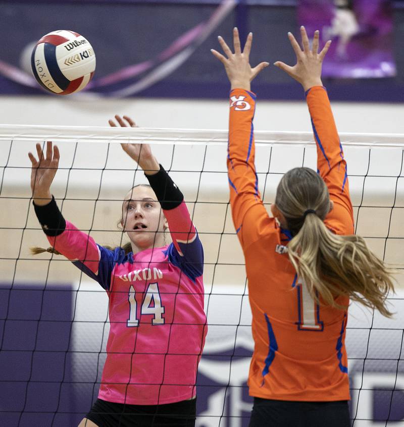 Dixon’s Leah Carlson sets the ball over the net against Genoa-Kingston’s Presley Meyer Thursday, Oct. 17, 2024.