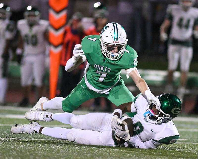 Glenbard West's Jaylen McMiller (9) catches the ball for a first down during the game while being defended by York's Drew Richardson (7) on Friday Oct. 17, 2025, held at York High School.