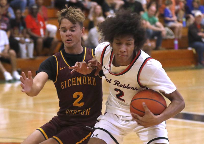 Huntley's Omare Segarra tries to spin away from the defense of Richmond-Burton's Maddox Meyer during the boy’s game of McHenry County Area All-Star Basketball Extravaganza on Sunday, April 14, 2024, at Alden-Hebron’s Tigard Gymnasium in Hebron.