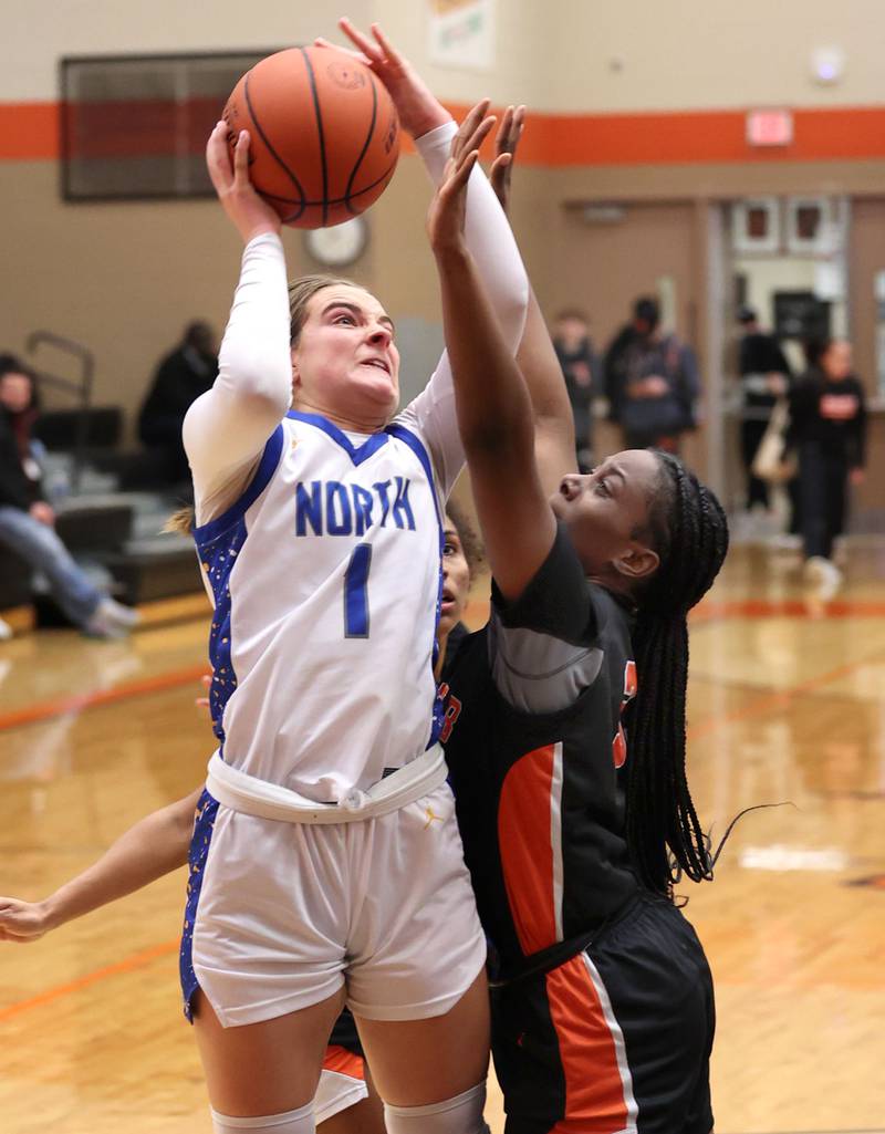 Wheaton North's Zoey Bohmer shoots over DeKalb’s Cayla Evans during their Class 4A regional game Monday, Feb 12, 2024, at DeKalb High School.