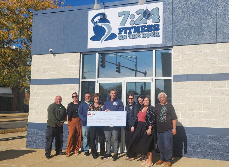 24:7 Fitness on the Rock in Rock Falls recently received a $5,000 check for facade improvements. Pictured (from left) are Brian Tribley, Tracy Finch, Tom Henry, Melinda Jones, Nick Pepper, Christina Wolfe, Marissa Razo, Sam Smith, and Mayor Rodney Kleckler.