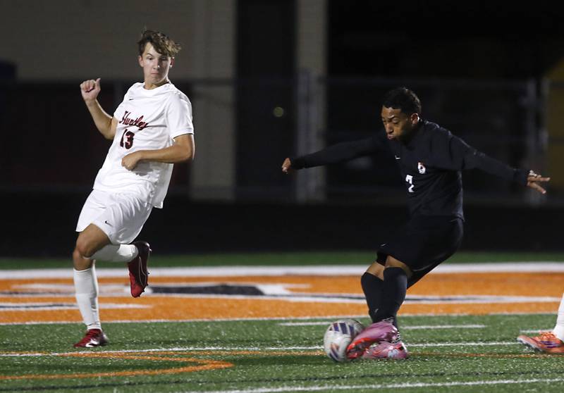 McHenry's Miguel Rondon shoots the ball into the goal as he is defended by Huntley's Ryan Andresen during a Fox Valley Conference boys soccer match on Thursday, Oct. 9, 2025, at McCracken Field in McHenry.