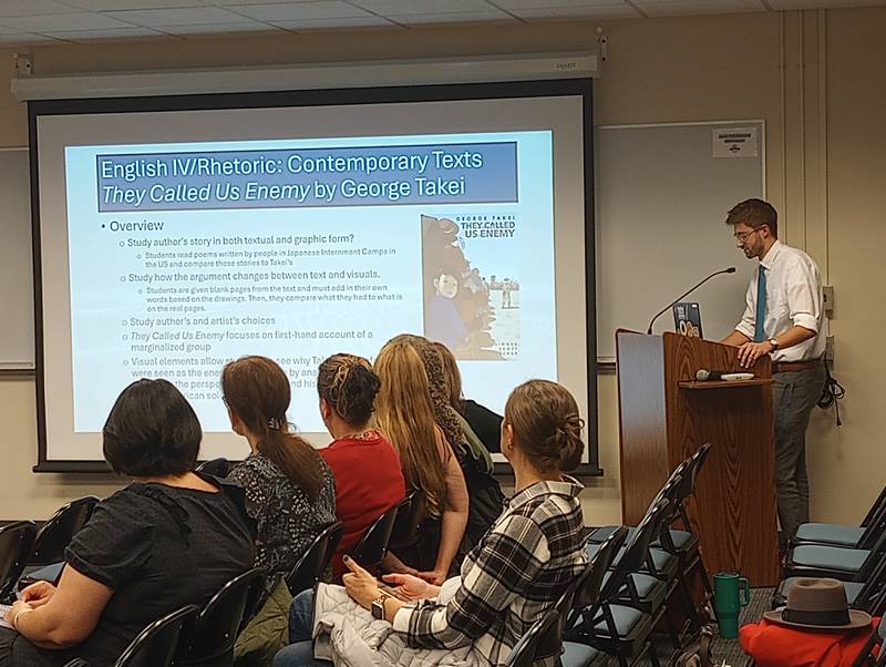 Geneva High School English teacher Andrew Cozzi explains how graphic novels tell stories in text and illustration at a District 304 school board meeting Nov. 11, 2024.
