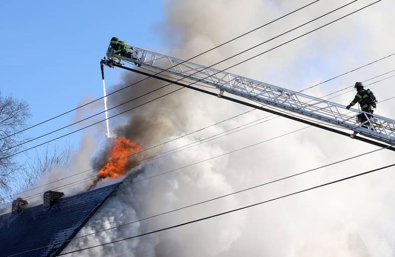 Flames work to extinguish flames during a structure fire in the 800 block of Bucklin Street on Friday, Jan. 23, 2026 in La Salle.