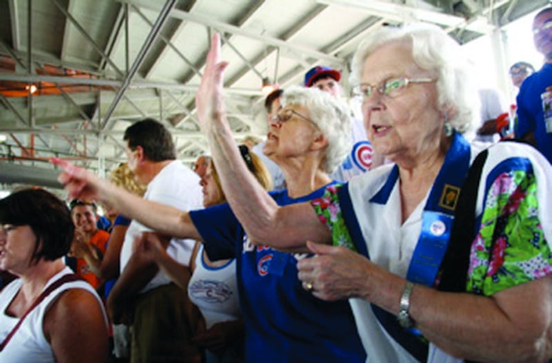 Betty Fish, 83, sings “Go Cubs Go” after the Cubs win Saturday. People from Dixon, Eureka College and Des Moines, Iowa, all traveled to Chicago as part of the Reagan centennial celebrations.