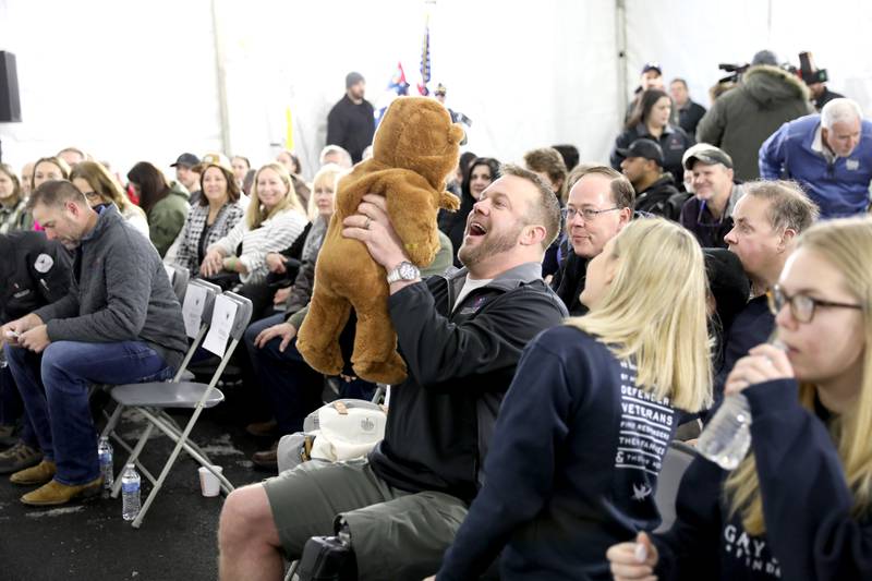 Retired U.S. Army Chief Warrant Officer 2 Patrick Scrogin holds up his infant son, Wyatt, during a dedication for his family’s newly constructed, specially adapted smart home in St. Charles on Thursday, Jan. 18, 2024. The mortgage-free home was made possible by the Gary Sinise Foundation.