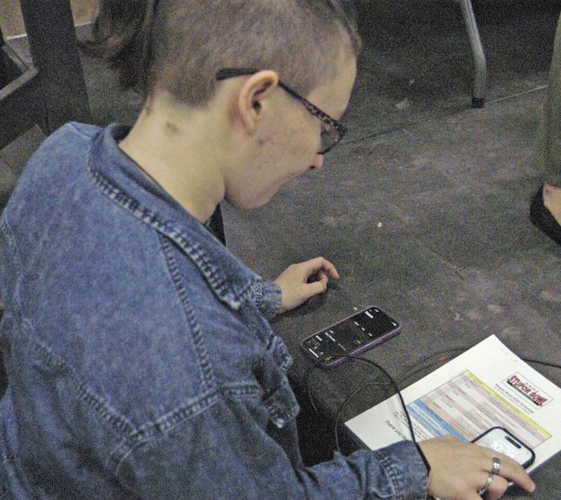 Grace Wadsworth keeps time and controls music at the Stupor Bowl on Saturday, Feb. 8, at Reagan Middle School in Dixon.