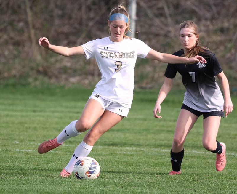 Sycamore's Marin Gautcher kicks the ball in front of Kaneland's Olivia Davis during their game Monday, April 13, 2026, at Kaneland High School.
