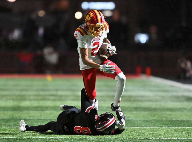 Batavia's Isaiah Brown (2) tries to break a tackle by Lincoln-Way Central's Gavin Barry (8) during the Class 7A semifinal playoff game on Saturday, Nov 23, 2024 at New Lenox. (Dean Reid for Shaw Local News)
