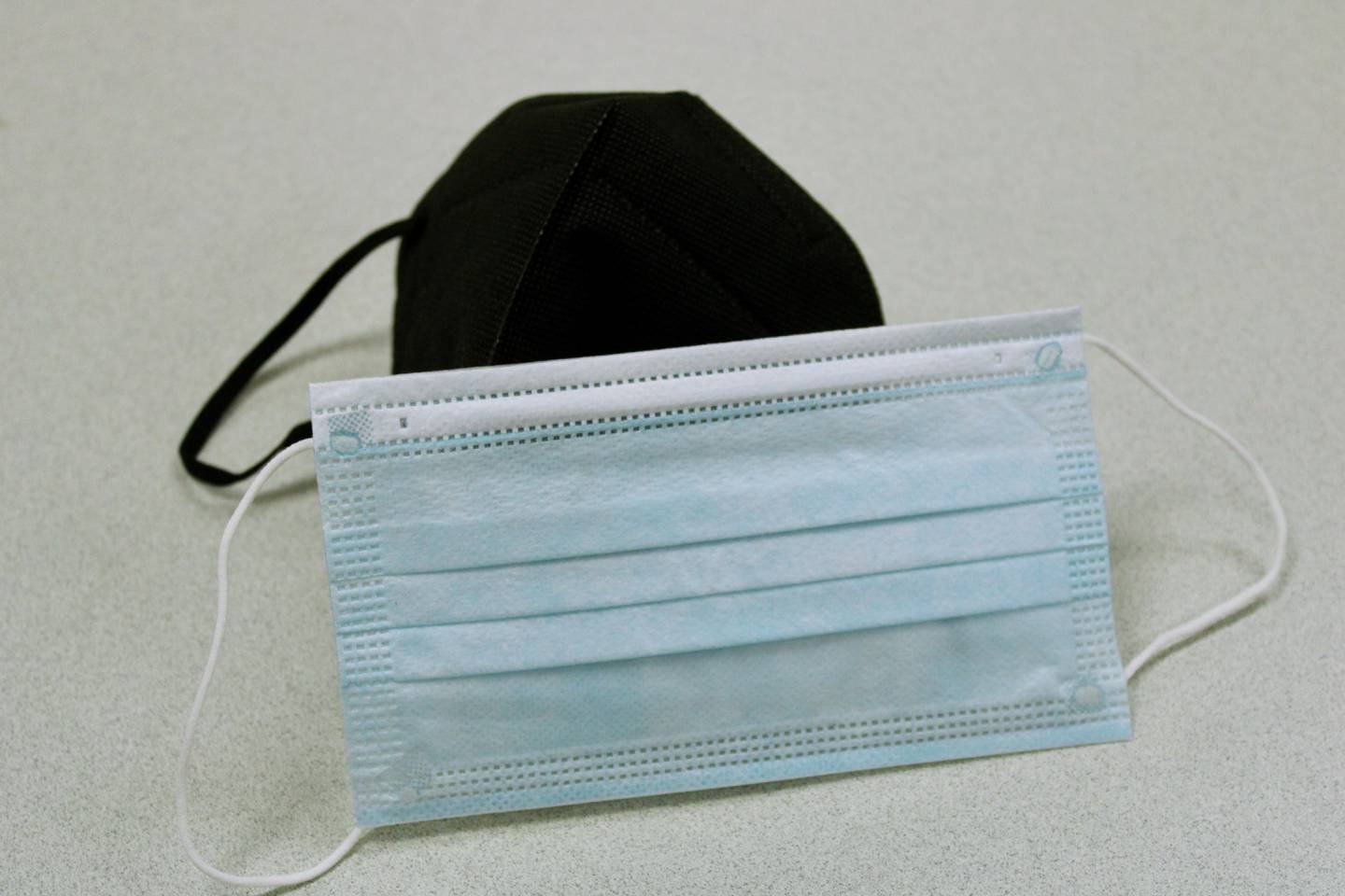 A KN95 black mask and a blue surgical style mask. The Lee County Health Department is recommending masks be worn indoors to prevent close contact infections, citing a rise of COVID-19 cases.