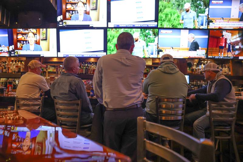 Patrons sit at the bar while watching sports at Corrigan’s Pub in Shorewood on Friday Mar. 1st, 2024.