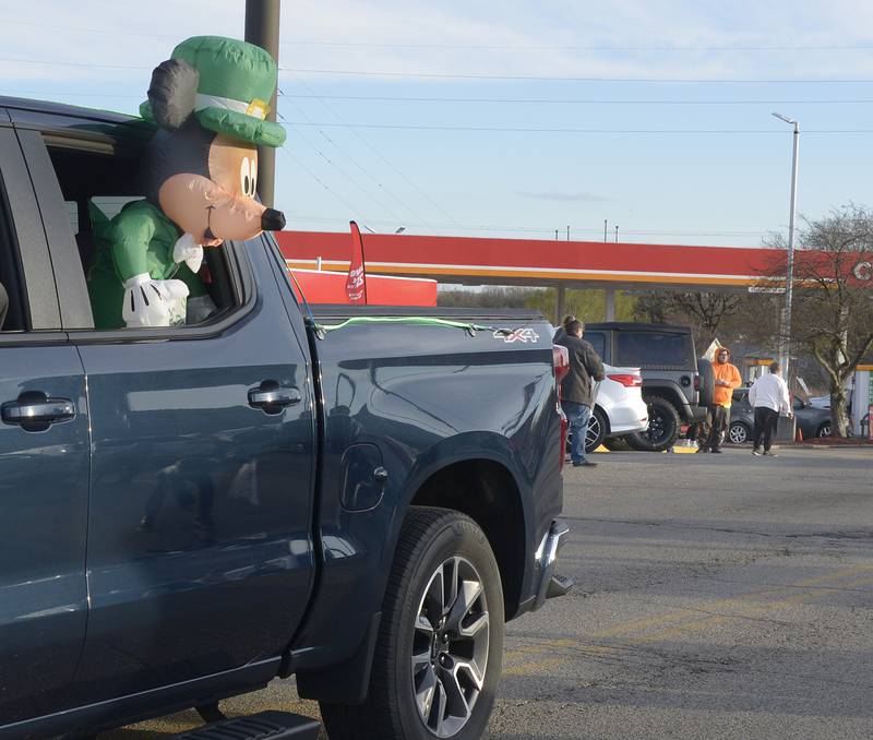 Mickey Mouse put on his Irish as he looks over the crowd along Main St in Marseilles Saturday during the annual St Patrick's Day Parade.