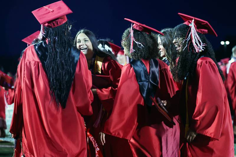 Graduates rush to celebrate with each other on the field following the Bradley-Bourbonnais Community High School commencement ceremony on Thursday, May 21, 2026.
