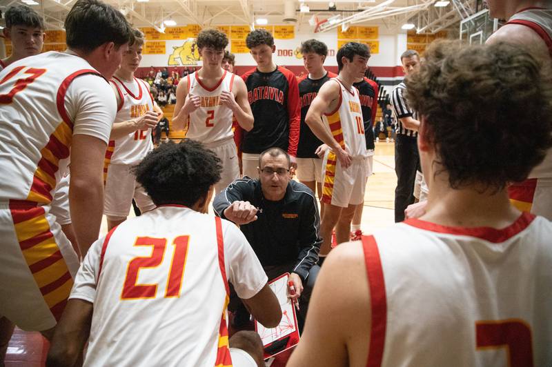 Batavia head coach Jim Nazos fist bumps his players between quarters during a home game against Wheaton Warrenville South on Tuesday, Jan. 7, 2025.