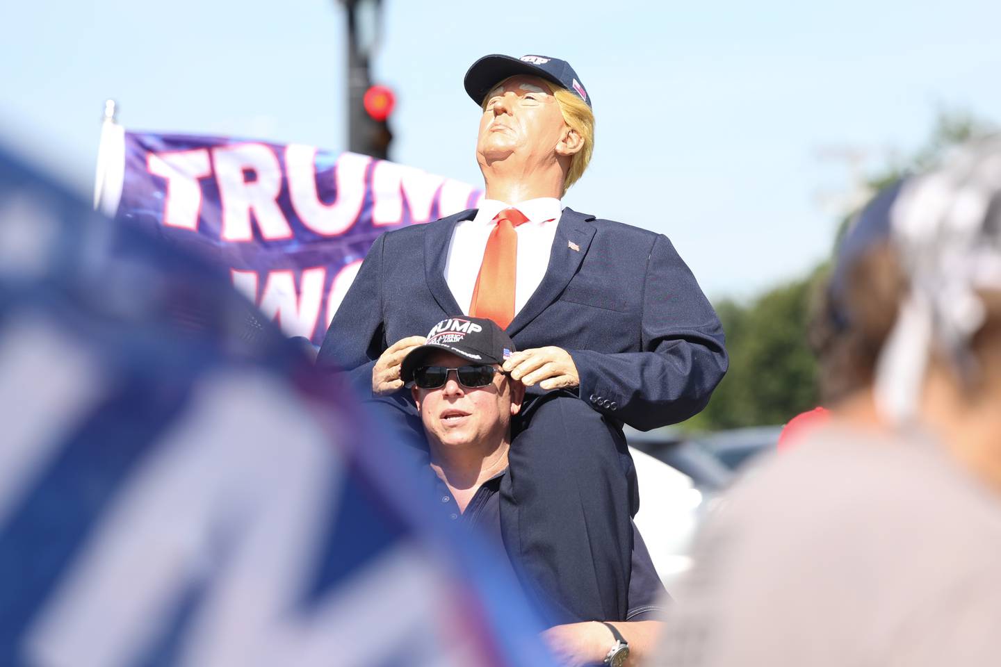 Jeff Berger, of Naperville, carries a Donald Trump mannequin during a protest along Lockport Street in Plainfield before the arrival of Vice President Kamala Harris. Friday, June 24, 2022 in Plainfield.