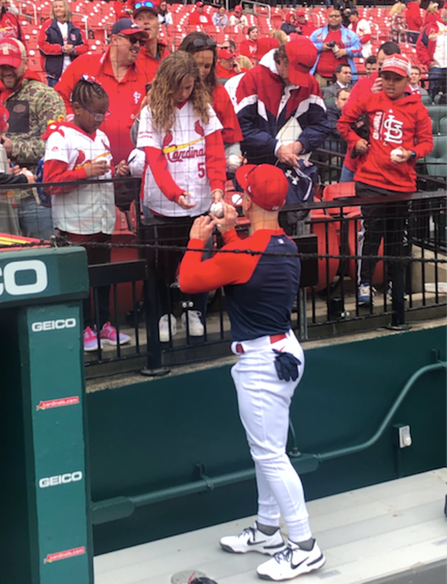 St. Louis Cardinals left fielder Tyler O'Neill signs autographs for young fans before Thursday's 2022 season opener. Then he went out and clubbed a three-run homer and drove in five runs to spark the Cardinals' 9-0 win over the Pirates.