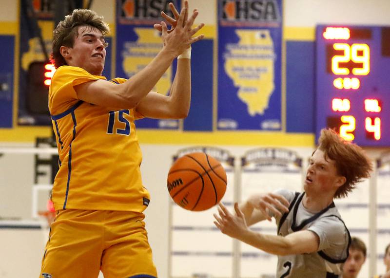 Johnsburg's Ashton Stern looses the ball as Cary-Grove's AJ Berndt reaches for it during a Johnsburg Thanksgiving Tournament boys basketball game on Monday, Nov. 24, 2025, at Johnsburg High School.
