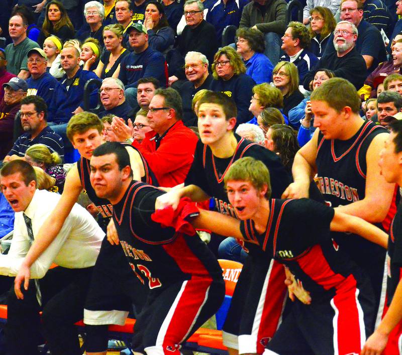 The Forreston bench reacts to the Cardinals taking the lead with 1.1 seconds left in the game against Aquin for the Eastland Sectional Championship. Forreston's Aaron Shelton was fouled and made the third of three free throws to take the lead. Photo by Chris Johnson
