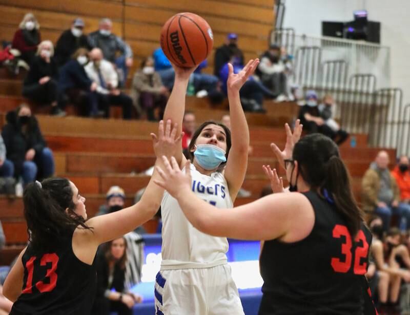 Princeton's Olivia Gartin shoots over Hall's McKenna Christiansen (13) and Toni Newton Monday night at Prouty Gym. The Tigresses rallied for a 40-32 victory.