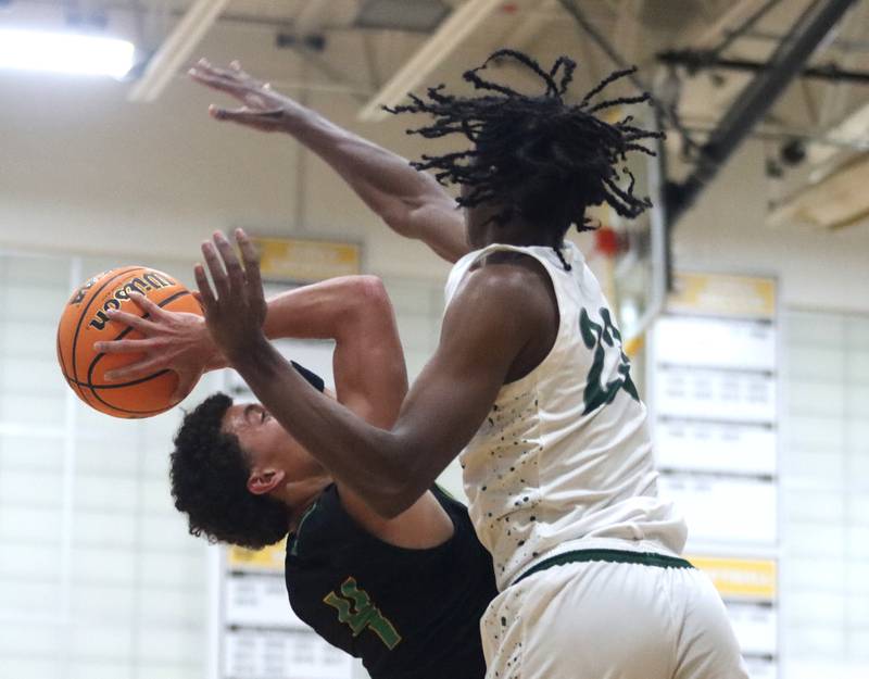 Crystal Lake South’s AJ Demirov, left, battles Grayslake Central’s Chris Jaimes under the hoop during Hinkle Holiday Classic varsity boys basketball tournament action on Thursday, Dec. 26, 2024 at Jacobs High School in Algonquin.