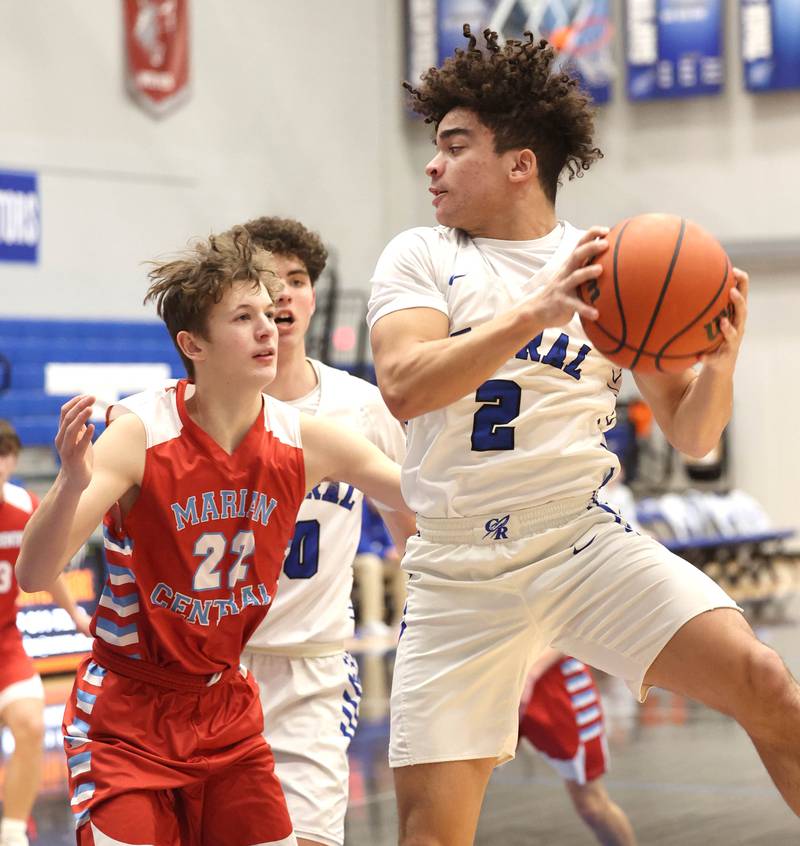 Burlington Central's Caden West grabs a rebound in front of Marian Central's Derek Leitzen Monday, Jan. 15, 2023, during their game in the Burlington Central Martin Luther King Jr. boys basketball tournament.
