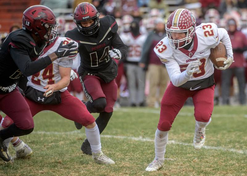 Morris' AJ Zweeres (23) looks for room to run against the Peoria High defense in the first half of their Class 5A football state semifinal Saturday, Nov. 19, 2022 at Peoria Stadium.