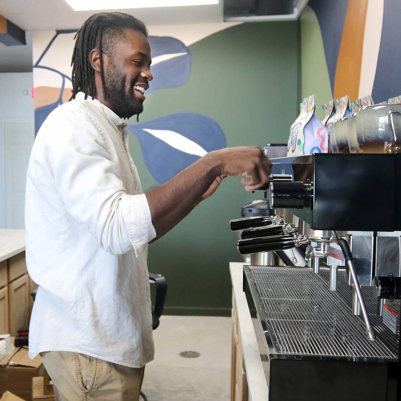 Troy Rorer, owner of The Greenhouse with his wife Kailey, sets up their new coffee bar Thursday, Feb. 29, 2024, at the store in Sycamore. The Greenhouse has expanded in size and will soon offer new services.