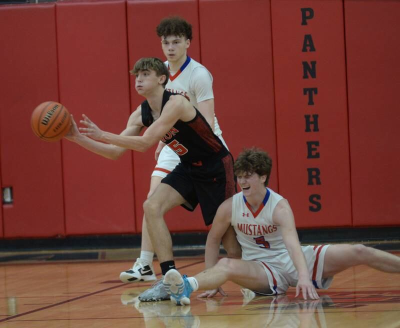 Fulton's Colten Randecker passes the ball as Morrison's Chase Newman hits the floor on Saturday, Dec. 30, 2023 at the Warkins Memorial Tournament at Erie High School.