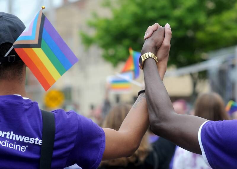 Terence and Travonte Eubans hold hands as they take part in the Woodstock PrideFest Parade Sunday, June 12, 2022, around the historic Woodstock Square. The parade, that is its third year, featured over 50 entries for the crowd of around 4,000 people to enjoy, according to city officials.